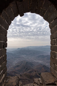 Scenic view of mountains against cloudy sky