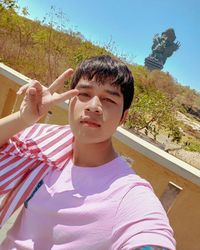 Portrait of young woman sitting on field