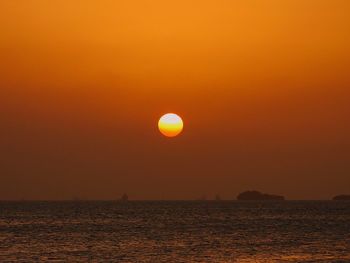 Scenic view of sea against orange sky