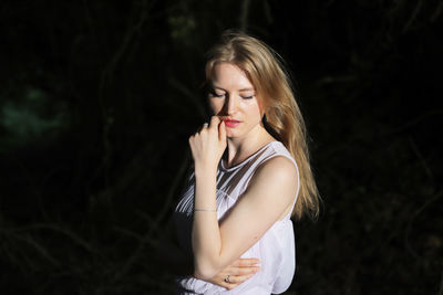 Beautiful woman standing in forest