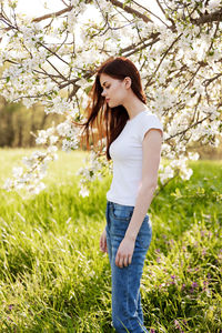 Young woman standing on field