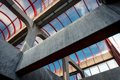 Low angle view of building against sky seen through window