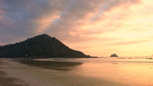 Scenic view of beach against sky during sunset