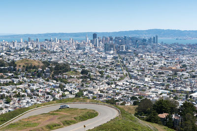 High angle view of city buildings against clear sky