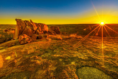 Scenic view of rock formation against sky during sunset