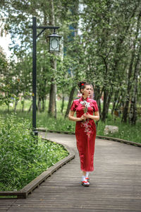 Rear view of woman standing in park