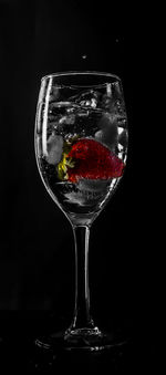 Close-up of beer glass against black background