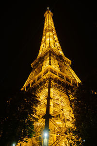 Low angle view of illuminated building against sky at night