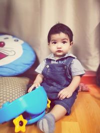 Cute baby boy sitting at home
