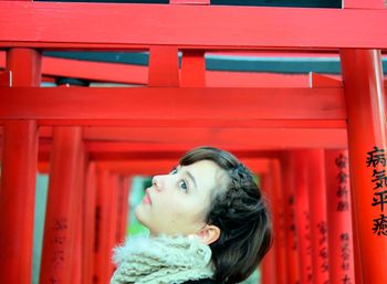 Portrait of a young woman looking away japanese girl at torii gate 