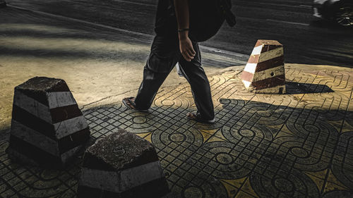 Low section of man standing on sidewalk