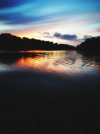 Scenic view of lake against cloudy sky