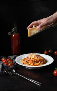 Close-up of person preparing food on table