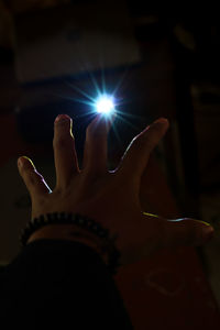 Close-up of person hand on illuminated stage