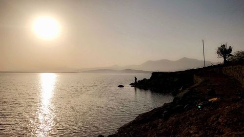 Scenic view of sea against clear sky during sunset