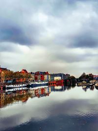 Houses by sea against sky in town