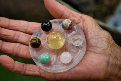 Close-up of hands holding marble