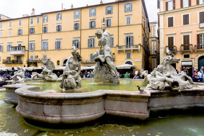 Statue of fountain in front of building