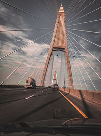 Bridge against sky seen through car windshield