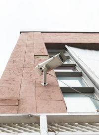 High angle view of electric lamp on roof against building