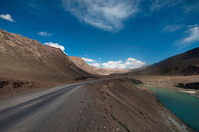 Scenic view of road by land against sky
