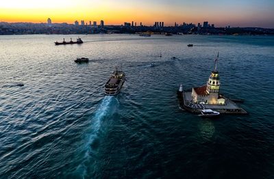 High angle view of cruise ship sailing in sea during sunset