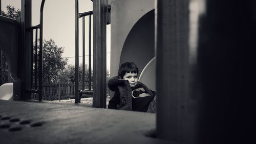 Boy sitting in corridor