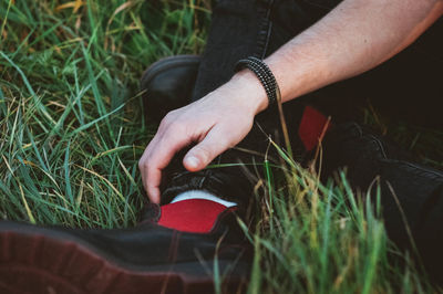 Low section of man sitting on field