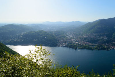 High angle view of lake and mountains against sky