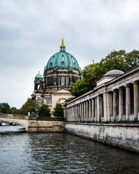 View of river by building against sky in berlin, germany 