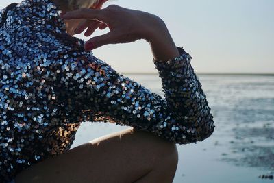 Low section of woman with arms raised