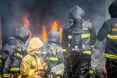 Firefighter spraying water on fire