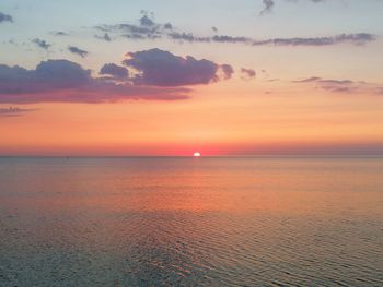 Scenic view of sea against orange sky