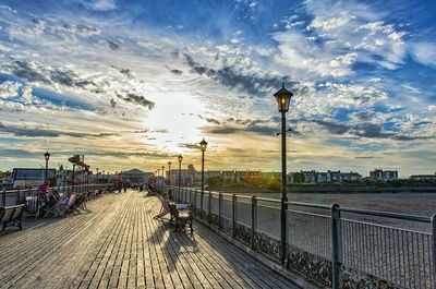 View of pier leading to sea