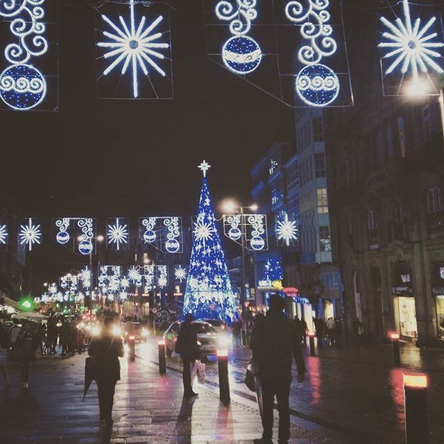 illuminated, night, architecture, large group of people, built structure, lifestyles, men, person, city life, building exterior, city, leisure activity, lighting equipment, street, walking, city street, mixed age range, crowd, group of people