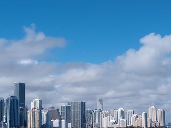 Modern buildings in city against sky