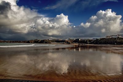 Scenic view of sea against cloudy sky