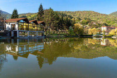 Scenic view of lake by trees against sky