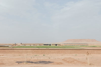 Scenic view of landscape against cloudy sky