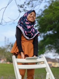 Portrait of a smiling girl with the gadget