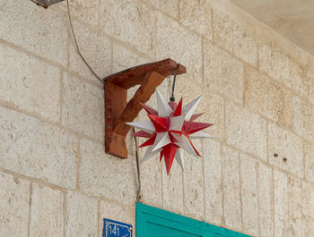 High angle view of red rose on wall