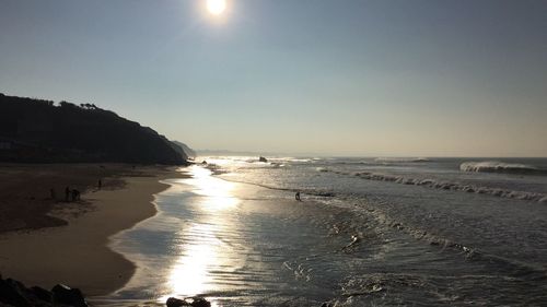 Scenic view of sea against clear sky at sunset