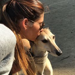 Woman kissing dog