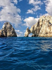 Panoramic view of rocks in sea against sky