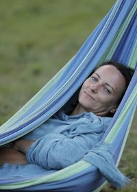 Portrait of woman relaxing on hammock