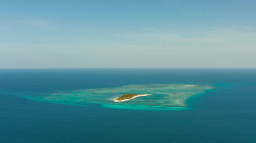 Small tropical island in the blue sea with a coral reef and the beach. canimeran island, balabac