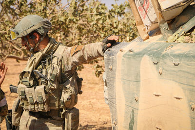 Soldier standing by bunker standing outdoors