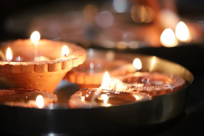 Close-up of diyas on table