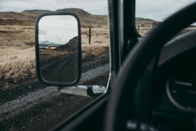 Reflection of car on side-view mirror