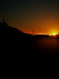 Silhouette landscape against sky during sunset